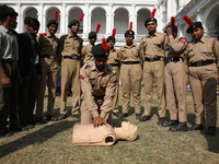 A medical official demonstrates lifesaving Cardiopulmonary Resuscitation (CPR) on a mannequin with breathing problems during a CPR training...