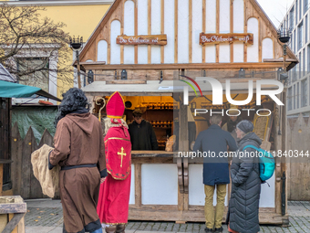 Visitors experience the festive atmosphere of the Medieval Christmas Market in Munich, Bavaria, Germany, on December 6, 2024. The market, lo...