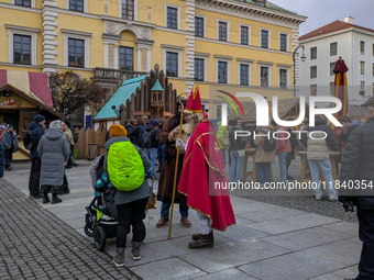 Visitors experience the festive atmosphere of the Medieval Christmas Market in Munich, Bavaria, Germany, on December 6, 2024. The market, lo...