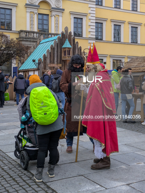 Visitors experience the festive atmosphere of the Medieval Christmas Market in Munich, Bavaria, Germany, on December 6, 2024. The market, lo...