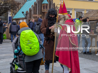 Visitors experience the festive atmosphere of the Medieval Christmas Market in Munich, Bavaria, Germany, on December 6, 2024. The market, lo...