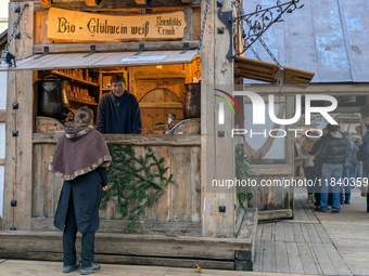 Visitors experience the festive atmosphere of the Medieval Christmas Market in Munich, Bavaria, Germany, on December 6, 2024. The market, lo...