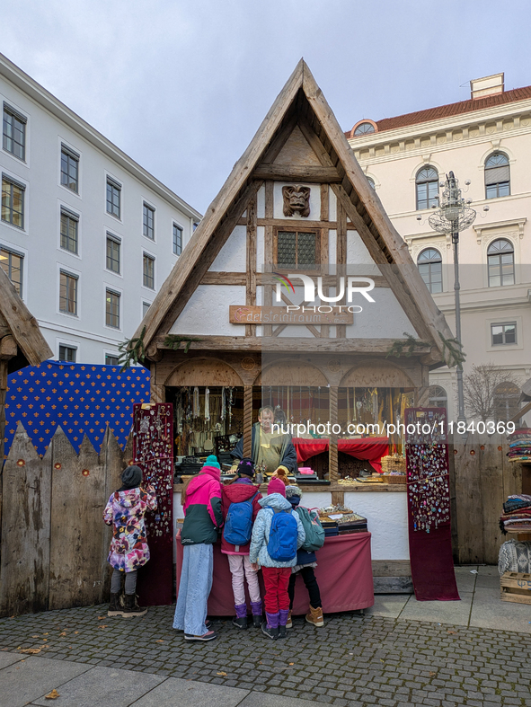 Visitors experience the festive atmosphere of the Medieval Christmas Market in Munich, Bavaria, Germany, on December 6, 2024. The market, lo...