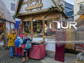 Visitors experience the festive atmosphere of the Medieval Christmas Market in Munich, Bavaria, Germany, on December 6, 2024. The market, lo...