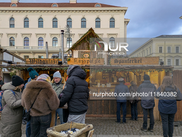 Visitors experience the festive atmosphere of the Medieval Christmas Market in Munich, Bavaria, Germany, on December 6, 2024. The market, lo...