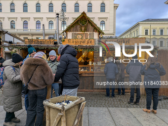 Visitors experience the festive atmosphere of the Medieval Christmas Market in Munich, Bavaria, Germany, on December 6, 2024. The market, lo...