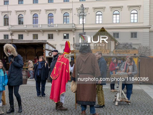 Visitors experience the festive atmosphere of the Medieval Christmas Market in Munich, Bavaria, Germany, on December 6, 2024. The market, lo...