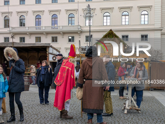 Visitors experience the festive atmosphere of the Medieval Christmas Market in Munich, Bavaria, Germany, on December 6, 2024. The market, lo...