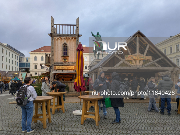 Visitors experience the festive atmosphere of the Medieval Christmas Market in Munich, Bavaria, Germany, on December 6, 2024. The market, lo...