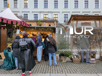 Visitors experience the festive atmosphere of the Medieval Christmas Market in Munich, Bavaria, Germany, on December 6, 2024. The market, lo...