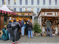 Visitors experience the festive atmosphere of the Medieval Christmas Market in Munich, Bavaria, Germany, on December 6, 2024. The market, lo...