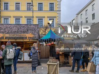 Visitors experience the festive atmosphere of the Medieval Christmas Market in Munich, Bavaria, Germany, on December 6, 2024. The market, lo...