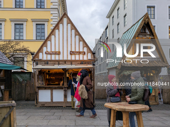 Visitors experience the festive atmosphere of the Medieval Christmas Market in Munich, Bavaria, Germany, on December 6, 2024. The market, lo...