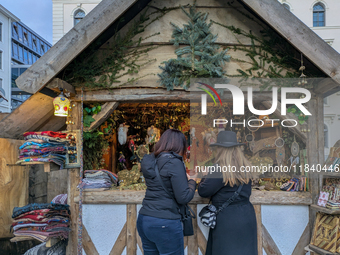 Visitors experience the festive atmosphere of the Medieval Christmas Market in Munich, Bavaria, Germany, on December 6, 2024. The market, lo...