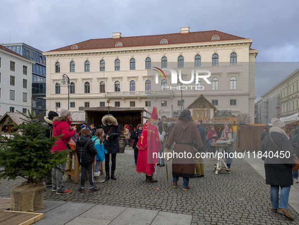 Visitors experience the festive atmosphere of the Medieval Christmas Market in Munich, Bavaria, Germany, on December 6, 2024. The market, lo...