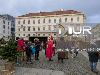 Visitors experience the festive atmosphere of the Medieval Christmas Market in Munich, Bavaria, Germany, on December 6, 2024. The market, lo...