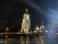 People walk around Ukraine's main Christmas tree before its lights are switched on amid Russia's attack on Ukraine in Sophia Square in Kyiv,...