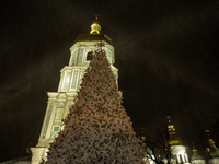 People walk around Ukraine's main Christmas tree before its lights are switched on amid Russia's attack on Ukraine in Sophia Square in Kyiv,...