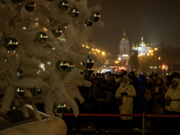 People walk around Ukraine's main Christmas tree before its lights are switched on amid Russia's attack on Ukraine in Sophia Square in Kyiv,...