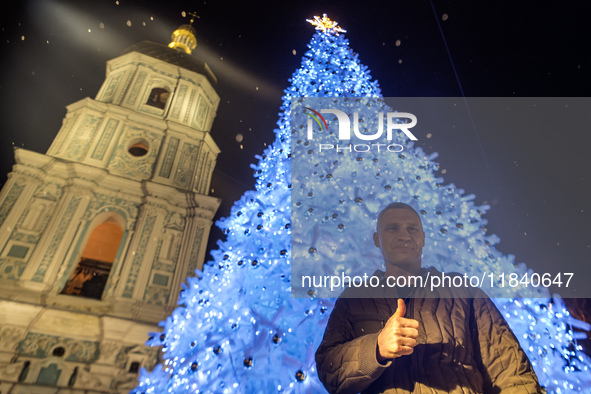 Kyiv Mayor Vitali Klitschko stands near Ukraine's main Christmas tree after its lights are switched on amid Russia's attack on Ukraine in So...