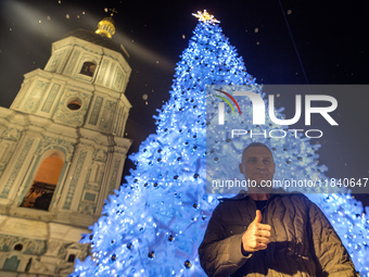 Kyiv Mayor Vitali Klitschko stands near Ukraine's main Christmas tree after its lights are switched on amid Russia's attack on Ukraine in So...