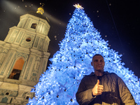 Kyiv Mayor Vitali Klitschko stands near Ukraine's main Christmas tree after its lights are switched on amid Russia's attack on Ukraine in So...