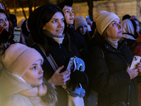 People walk around Ukraine's main Christmas tree after its lights are switched on amid Russia's attack on Ukraine in Sophia Square in Kyiv,...