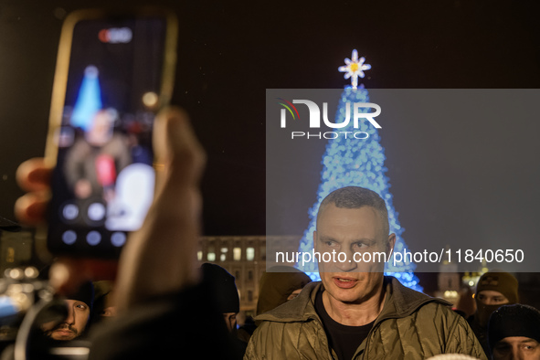 Kyiv Mayor Vitali Klitschko stands near Ukraine's main Christmas tree after its lights are switched on amid Russia's attack on Ukraine in So...