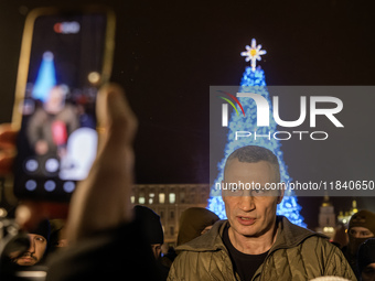 Kyiv Mayor Vitali Klitschko stands near Ukraine's main Christmas tree after its lights are switched on amid Russia's attack on Ukraine in So...