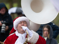 A local band dresses like Santa Claus before Santa Claus arrives by helicopter in Essen Steele, Germany, on December 6, 2024. (