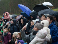 Children with parents wait for the landing of the helicopter with Santa Claus in Essen Steele, Germany, on December 6, 2024. (