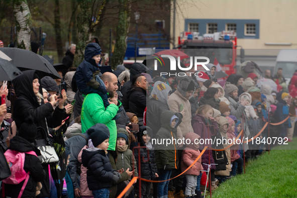 Children with parents wait for the landing of the helicopter with Santa Claus in Essen Steele, Germany, on December 6, 2024. 