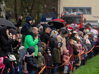 Children with parents wait for the landing of the helicopter with Santa Claus in Essen Steele, Germany, on December 6, 2024. (