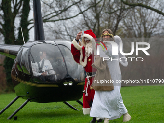 Santa Claus with an angel arrives in Essen Steele, Germany, on December 6, 2024. (