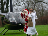 Santa Claus with an angel arrives in Essen Steele, Germany, on December 6, 2024. (