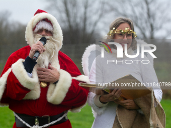 Santa Claus with an angel arrives in Essen Steele, Germany, on December 6, 2024. (