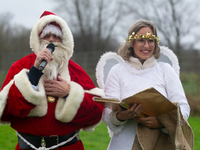 Santa Claus with an angel arrives in Essen Steele, Germany, on December 6, 2024. (