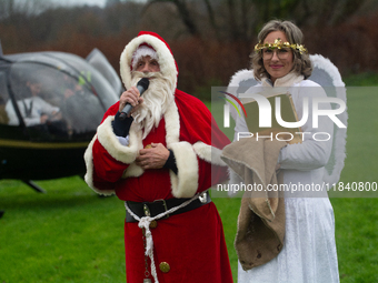 Santa Claus with an angel arrives in Essen Steele, Germany, on December 6, 2024. (