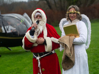 Santa Claus with an angel arrives in Essen Steele, Germany, on December 6, 2024. (