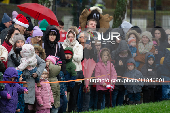 Children with parents wait for the landing of the helicopter with Santa Claus in Essen Steele, Germany, on December 6, 2024. 