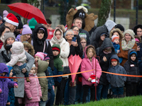 Children with parents wait for the landing of the helicopter with Santa Claus in Essen Steele, Germany, on December 6, 2024. (