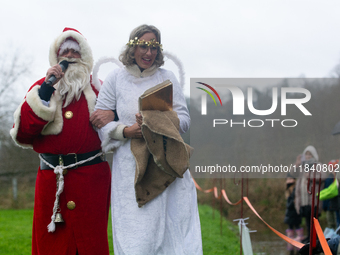 Santa Claus with an angel arrives in Essen Steele, Germany, on December 6, 2024. (