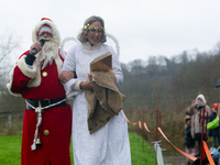 Santa Claus with an angel arrives in Essen Steele, Germany, on December 6, 2024. (