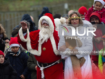 Santa Claus with an angel arrives in Essen Steele, Germany, on December 6, 2024. (