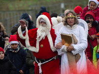 Santa Claus with an angel arrives in Essen Steele, Germany, on December 6, 2024. (