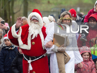 Santa Claus with an angel arrives in Essen Steele, Germany, on December 6, 2024. (