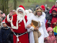 Santa Claus with an angel arrives in Essen Steele, Germany, on December 6, 2024. (