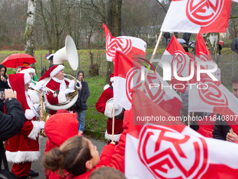 A local band dresses like Santa Claus before Santa Claus arrives by helicopter in Essen Steele, Germany, on December 6, 2024. (