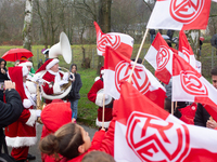 A local band dresses like Santa Claus before Santa Claus arrives by helicopter in Essen Steele, Germany, on December 6, 2024. (