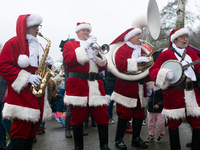 A local band dresses like Santa Claus before Santa Claus arrives by helicopter in Essen Steele, Germany, on December 6, 2024. (